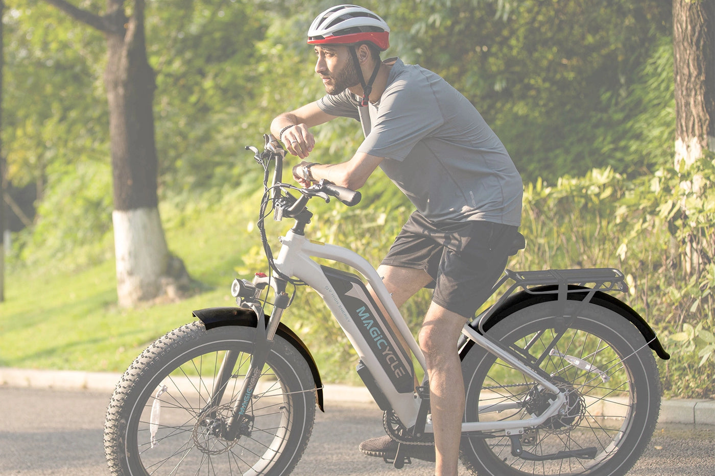 Man riding Magicycle electric bike in a park, promoting outdoor adventure