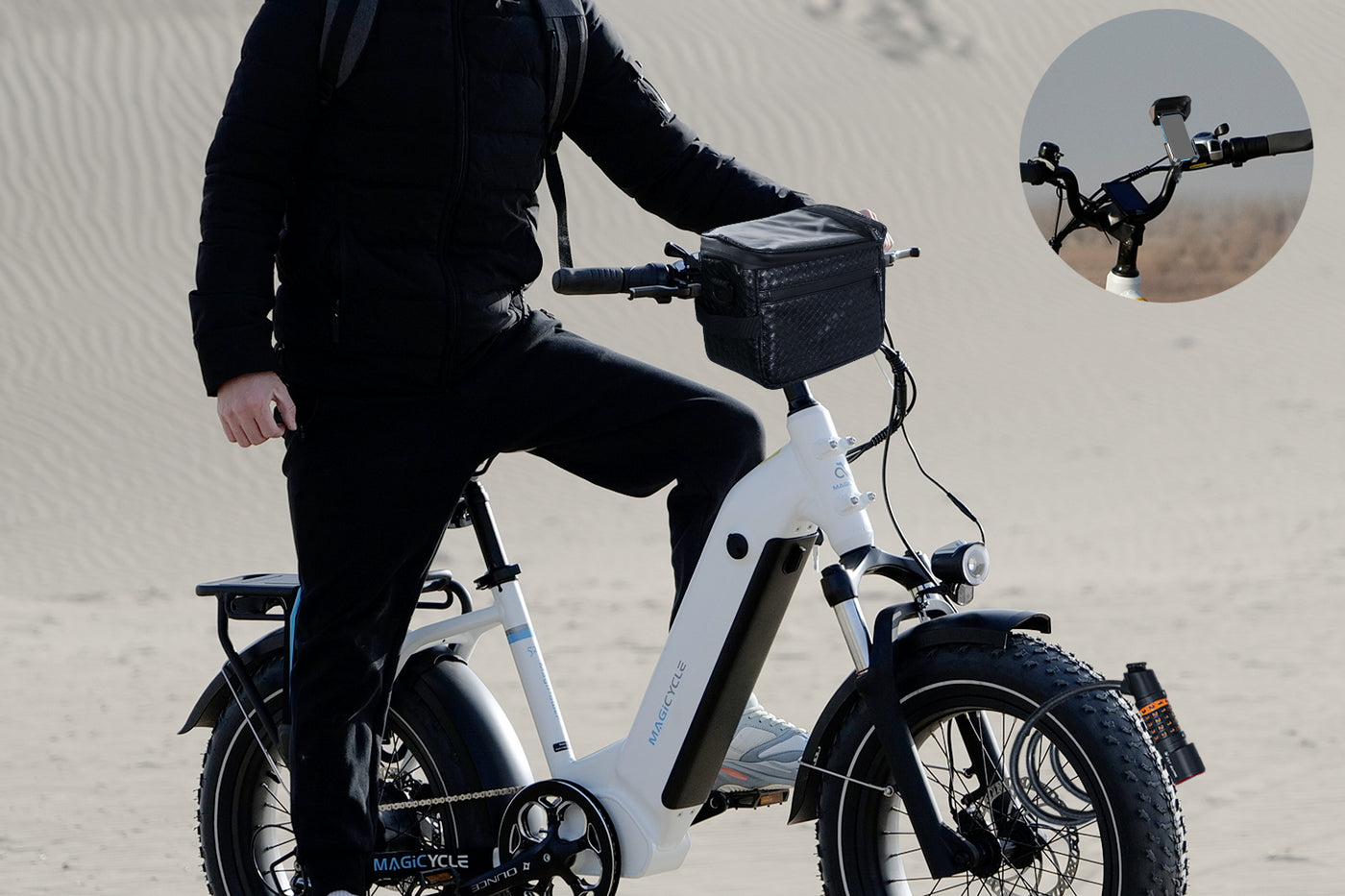 Person riding white fat tire e-bike with water bottle and phone mount.