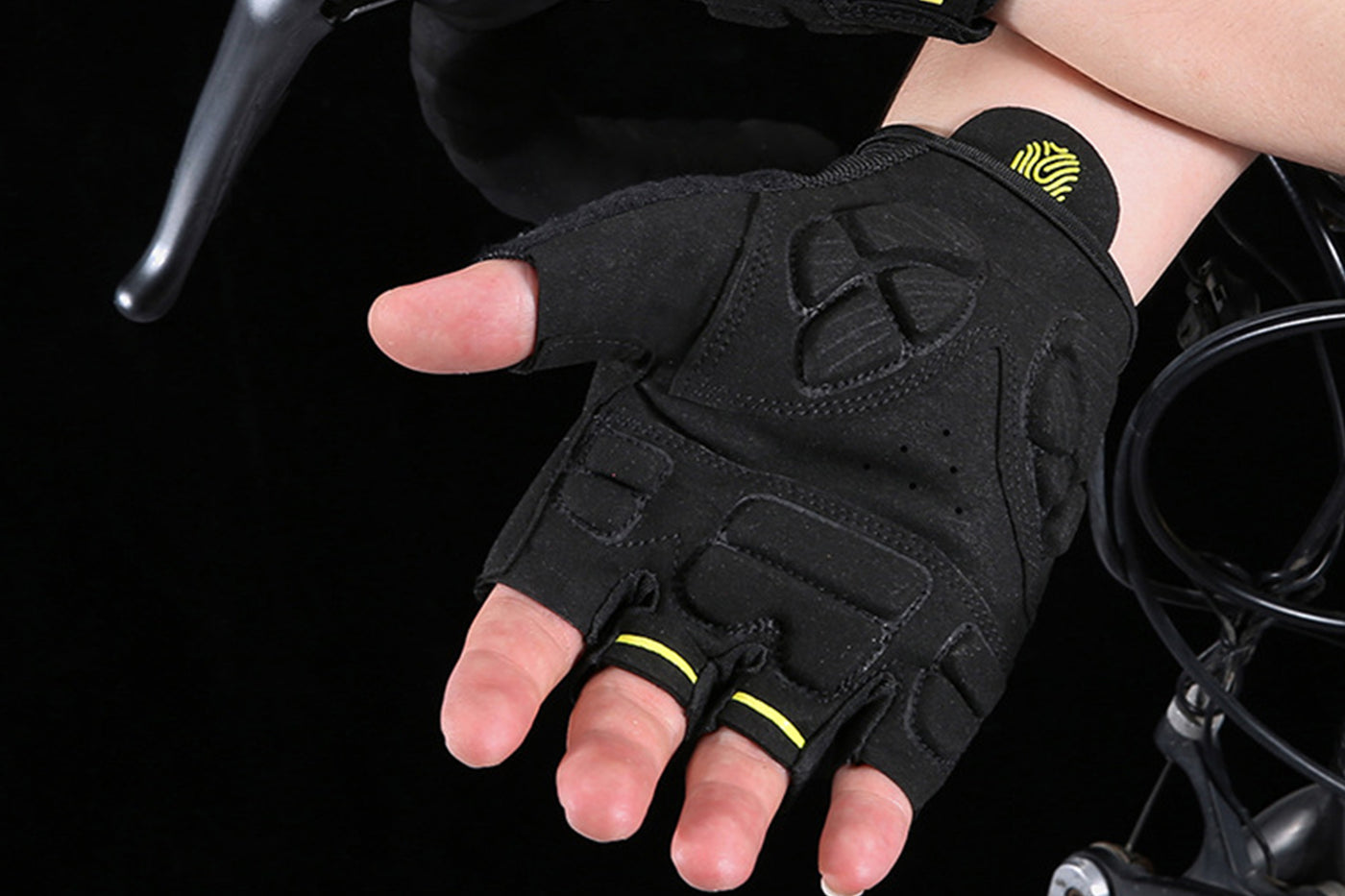 Half-finger cycling gloves in black with yellow highlights, designed for grip and comfort.