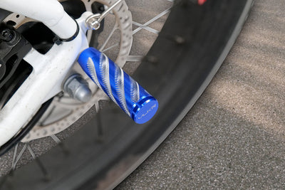 Blue non-slip rear foot pegs on an electric bike for passenger safety