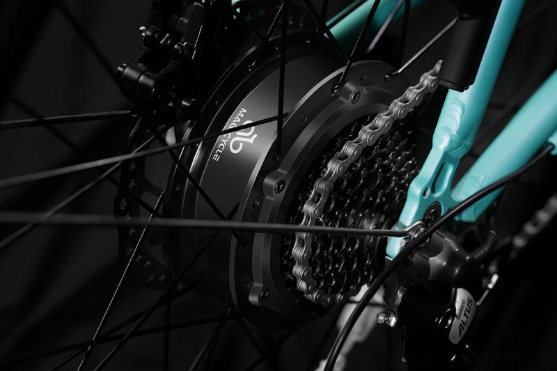 Close-up of Magicycle CT-1 ebike's rear hub motor and chain system in teal.