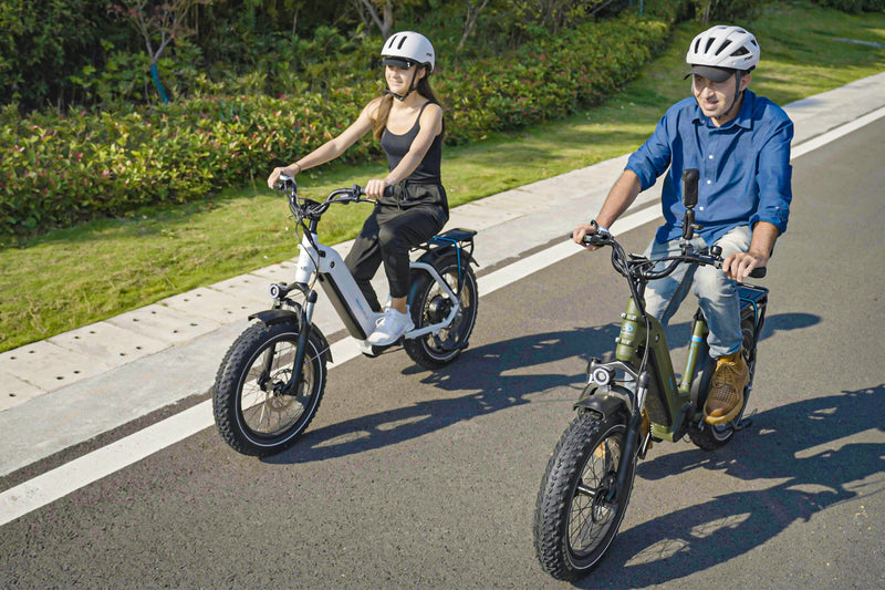 Two riders on Magicycle Ocelot Pro 2.0 electric bikes on a road